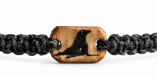 Cast Away bracelet in black braided cord with a wooden charm engraved with a bird