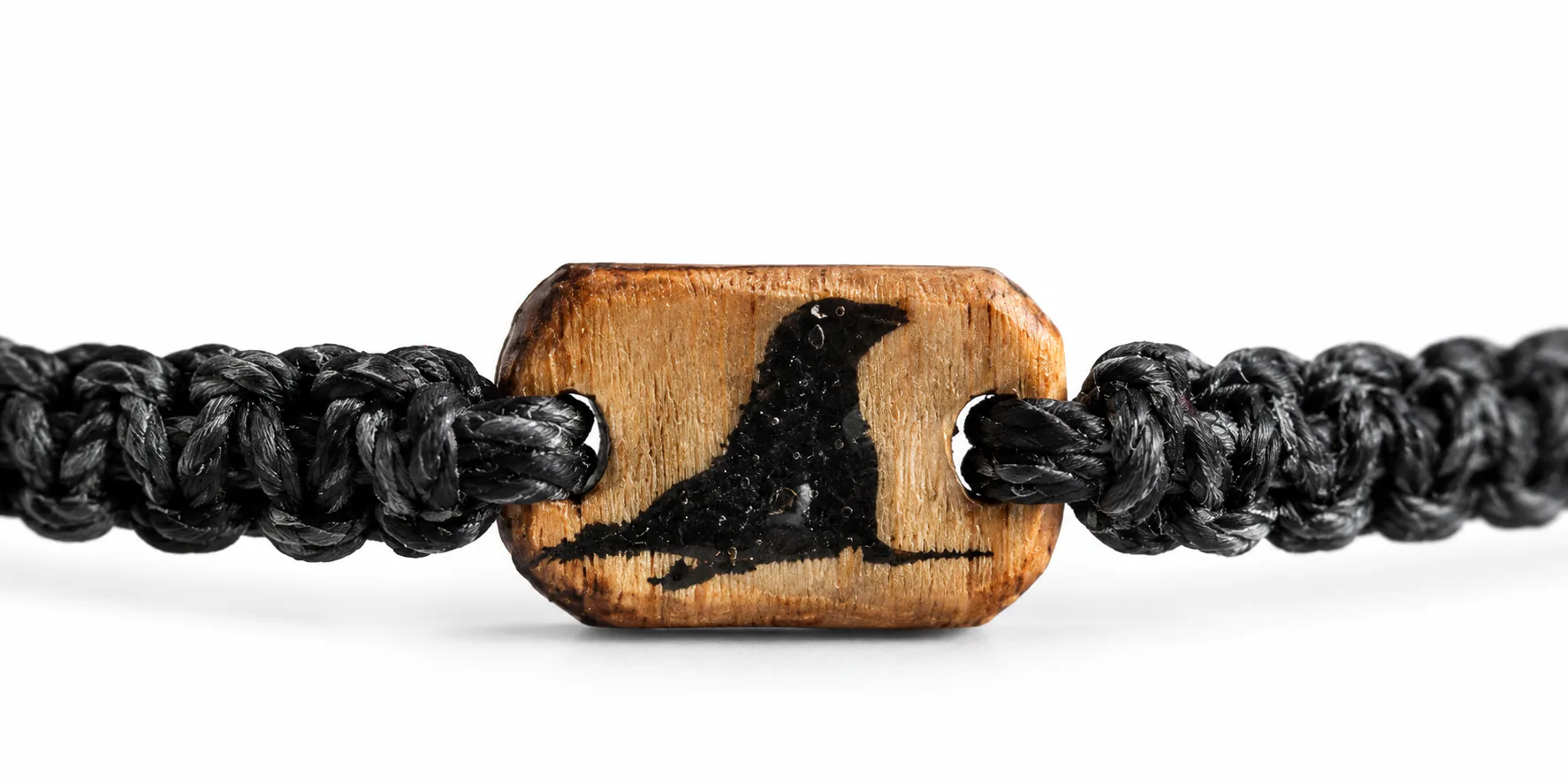 Cast Away bracelet in black braided cord with a wooden charm engraved with a bird