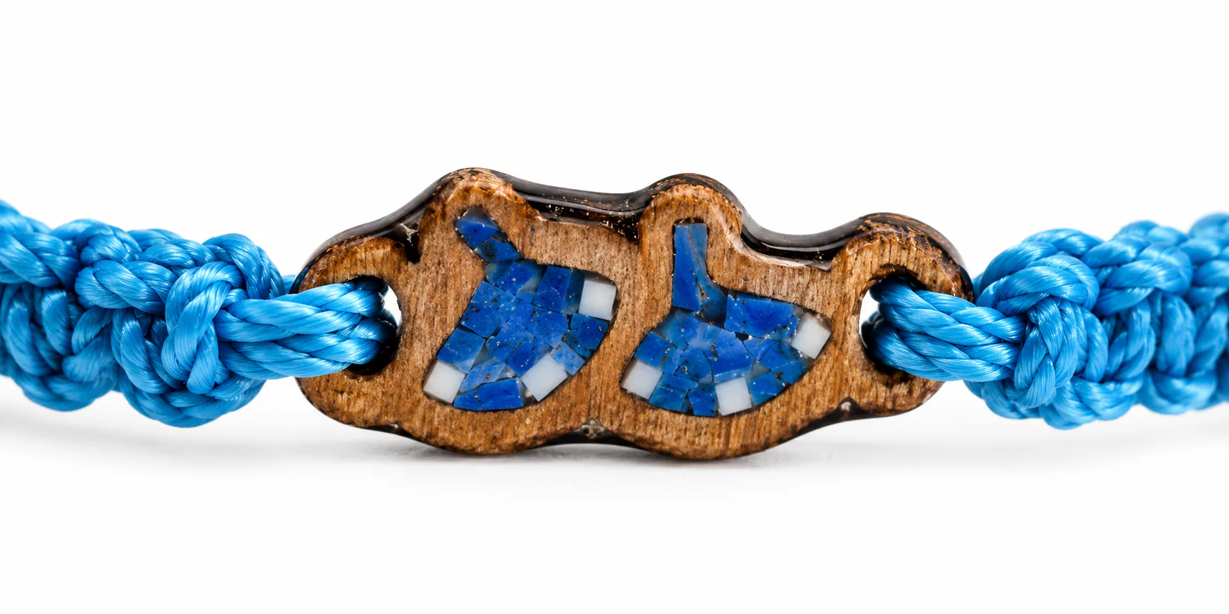 Close-up of the blue Cast Away bracelet wooden charm with blue inlay