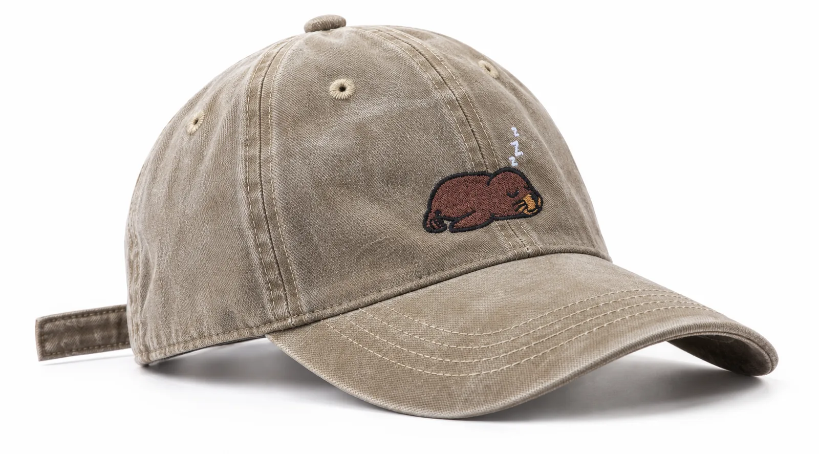 Sand cap with a sleepy sea lion embroidered on the front, side view