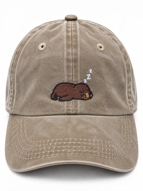 Sand cap with a sleepy sea lion embroidered on the front