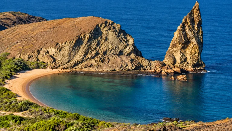 Pinnacle Rock and golden beach seen from Bartolome Island, Galapagos