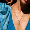 Woman wearing the Galapagos for Life blue-footed booby necklace