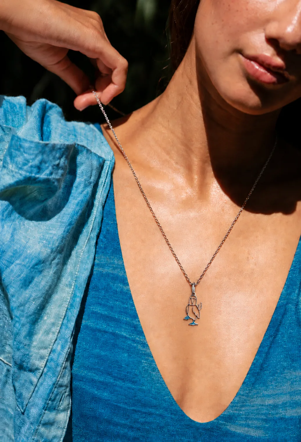 Woman wearing the Galapagos for Life blue-footed booby necklace